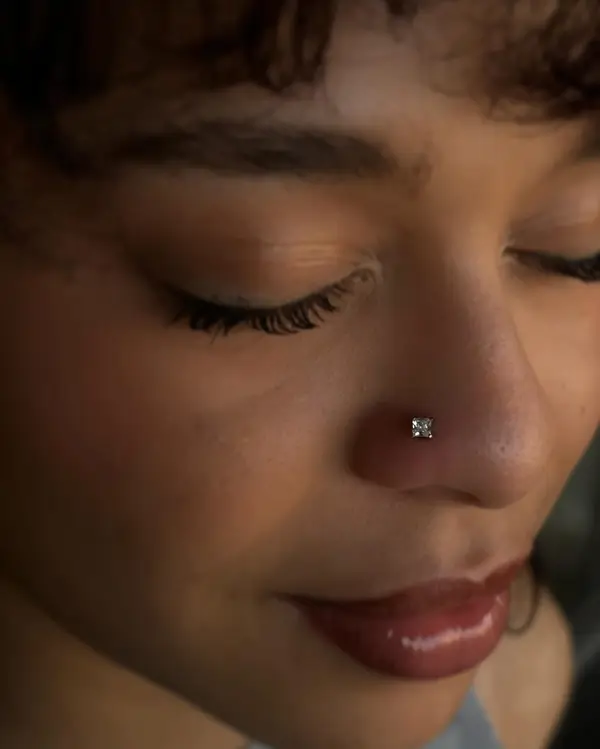 Nostril piercing with a princess-cut gem stud by T (Piercing Piranha) at Modified Tattoo Gallery in Winter Park, FL