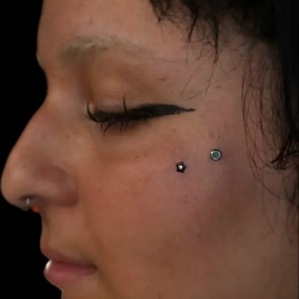 Anti-eyebrow piercings with a star and disc stud, plus a nostril piercing by T (Piercing Piranha) at Modified Tattoo Gallery in Winter Park, FL