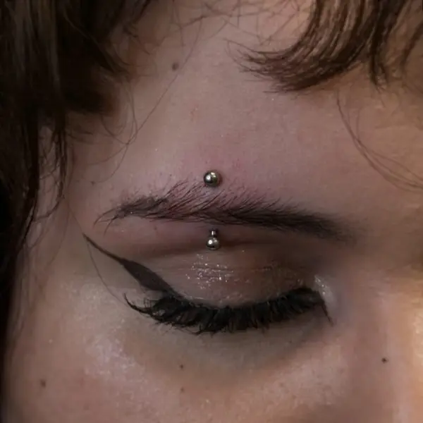 Eyebrow piercing with a curved barbell by T (Piercing Piranha) at Modified Tattoo Gallery in Winter Park, FL